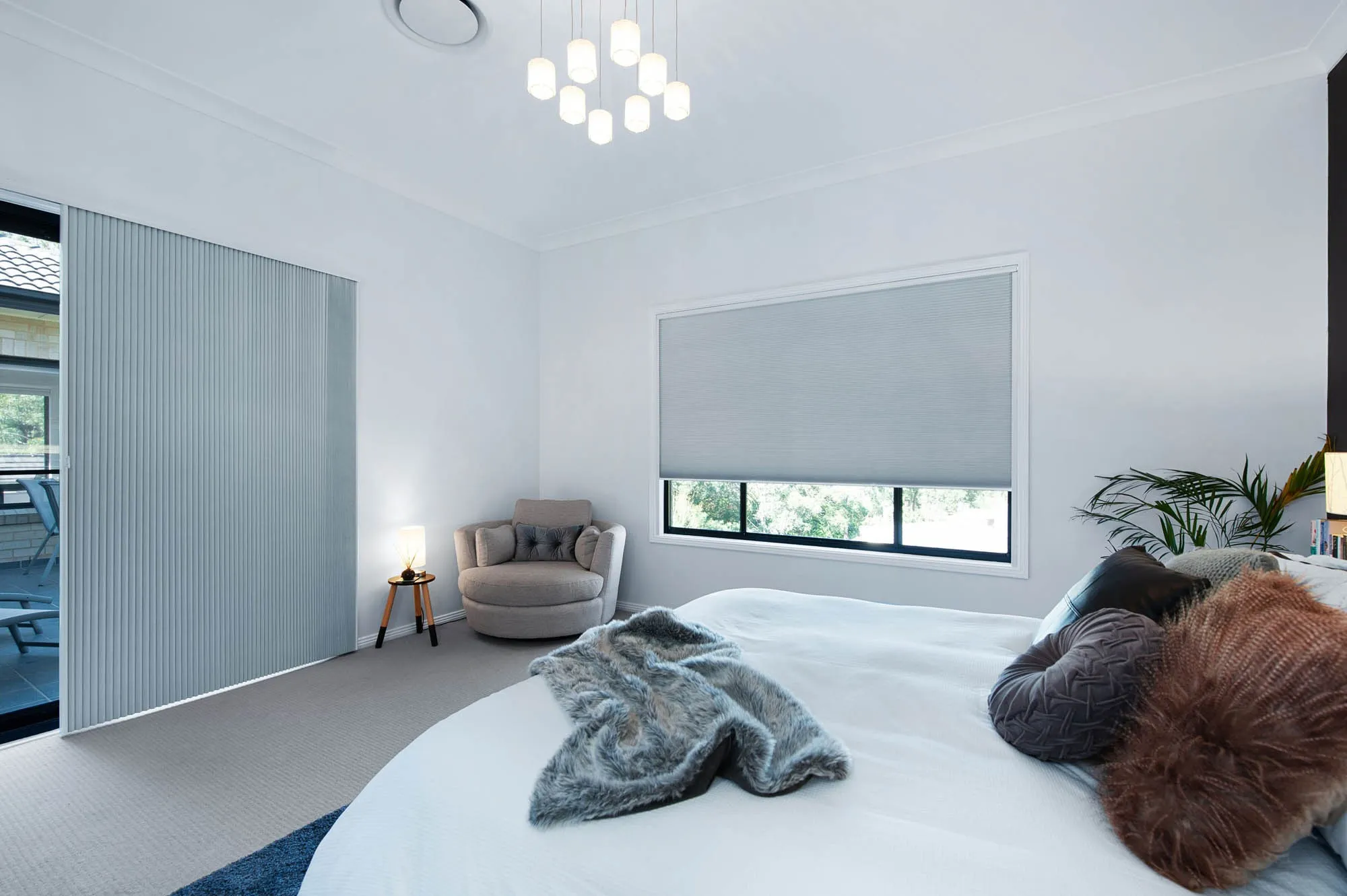 Pale grey blinds on a bedroom window and sliding door